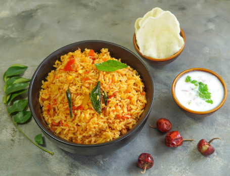 Thakkali Sadam (Tomato Rice) With Rice Crisps And Raita