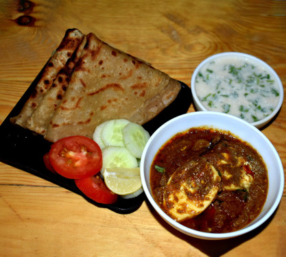 Egg Curry 2 Paratha Raita Salad.