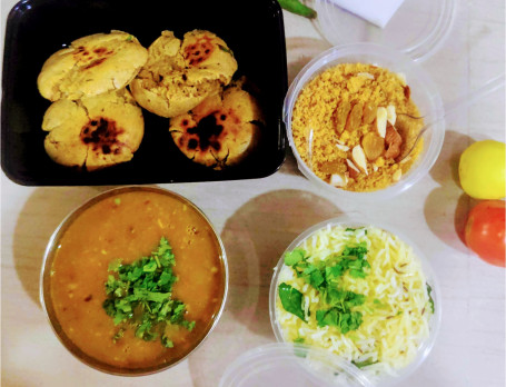 Butter Tadka Dal(500Ml) Masala Bati(4Pieces) Salad Tradditional Churma (100 Grams) Jeera Rice (200 Ml)