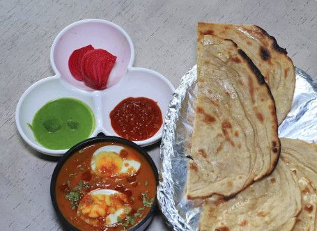 Egg Curry Laccha Paratha Meal .
