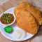 Chole Bhature( 1 Plate Served with sliced onions, Green Chilies, and Packaged Juice 180ml on the Side)